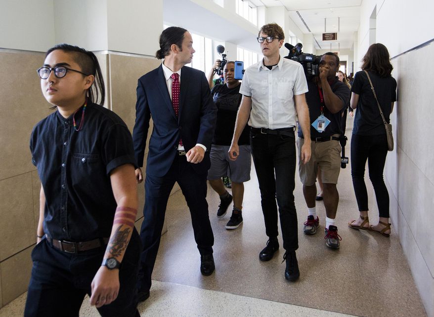 FILE - In a Thursday, Aug. 17, 2017 file photo, from left, Ngoc Loan Tran, 24, Peter Gull Gilbert, 36, and Dante Strobino, 35, leave a courtroom in the Durham County Courthouse after their first court appearance after being arrested for the toppling of the Durham County confederate statue during a protest, in Durham, NC. A North Carolina judge trying protesters accused of toppling a Confederate statue on Monday, Feb. 19, 2018, dismissed the criminal case against Strobino. (Casey Toth/The Herald-Sun via AP, File)