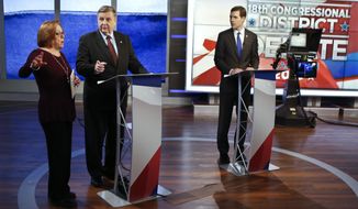 Republican Rick Saccone, center, and Democrat Connor Lamb, right, are prepped for the taping of their first debate in the special election in the Pa., 18th Congressional District at the KDKA TV studios, Monday, Feb. 19, 2018, in Pittsburgh. The debate was recorded in the afternoon and scheduled to be broadcast at 7 PM Monday. (AP Photo/Keith Srakocic)