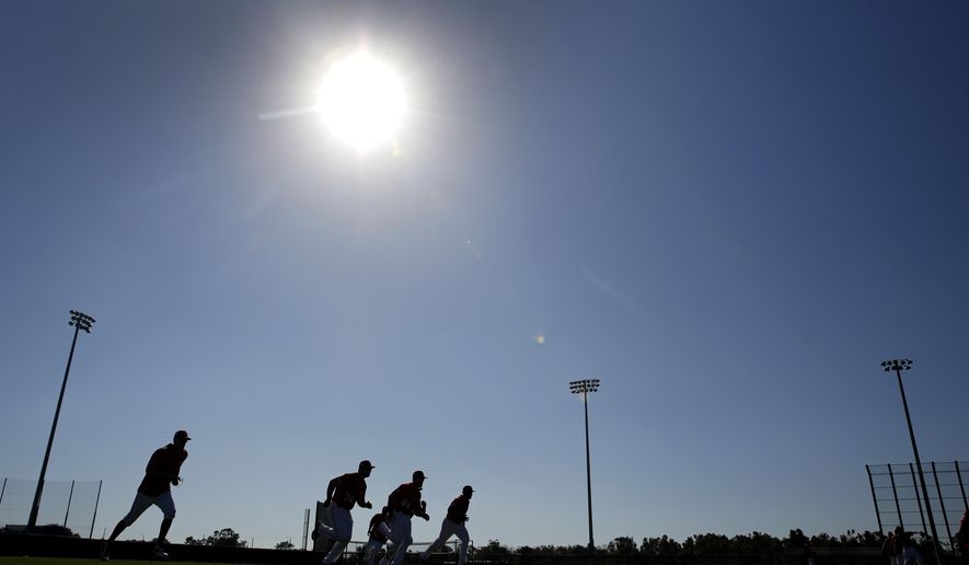 Members of the Washington Nationals run sprints during spring training baseball practice Saturday, Feb. 17, 2018, in West Palm Beach, Fla. (AP Photo/Jeff Roberson)