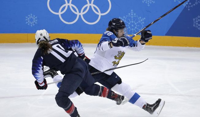 Meghan Duggan (10), of the United States, and Ronja Savolainen, of Finland, collide during the first period of the semifinal round of the women&#x27;s hockey game at the 2018 Winter Olympics in Gangneung, South Korea, Monday, Feb. 19, 2018. (AP Photo/Julio Cortez)