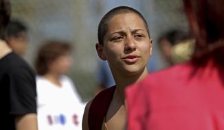 Emma Gonzalez, a senior who survived Wednesday&#x27;s shooting at Marjory Stoneman Douglas High School, talks with people at North Community Park in Parkland, Fla., Sunday, Feb. 18, 2018. Gonzalez is one of the students who escaped the deadly school shooting and focused their anger Sunday at President Donald Trump, contending that his response to the attack has been needlessly divisive. (John McCall/South Florida Sun-Sentinel via AP)