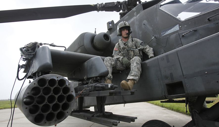 U.S. soldier Adam Elkins, chief warrant officer of 4th Aviation Attack Battalion 2nd Combat Aviation Brigade, sits on an AH-64D Apache attack helicopter as he waits for a live-fire drill at a U.S. air base in Gunsan, about 270 km (168 miles) south of Seoul, South Korea, Tuesday, July 21, 2009.  (AP Photo/Jo Yong-hak, Pool) ** FILE **