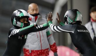 Driver Seun Adigun, right, and Akuoma Omeoga of Nigeria finish their second heat during the women&#39;s two-man bobsled competition at the 2018 Winter Olympics in Pyeongchang, South Korea, Tuesday, Feb. 20, 2018. (AP Photo/Andy Wong)