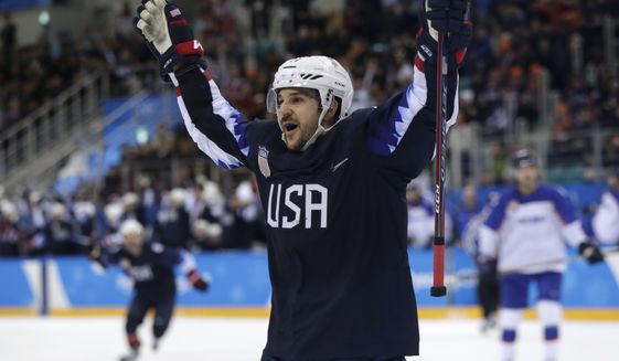 Garrett Roe (11), of the United States, celebrates after scoring a goal against Slovakia during the third period of the qualification round of the men&#39;s hockey game at the 2018 Winter Olympics in Gangneung, South Korea, Tuesday, Feb. 20, 2018. (AP Photo/Julio Cortez)