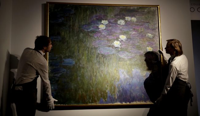 Christie&#x27;s London auction house staff pose for photographs with Claude Monet&#x27;s &#x27;Nympheas en fleur&#x27;, which will feature in the upcoming May 7-11 New York sale of the collection of Peggy and David Rockefeller, at their premises in London, Tuesday, Feb. 20, 2018. The Monet is estimated to fetch $50 million-$70 million (35.7 million to 50 million pounds, 40.5million to 56.7 million euro). The art collection amassed by billionaire David Rockefeller could raise more than $500 million for charity when it is auctioned this spring. (AP Photo/Matt Dunham)