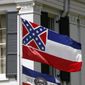 This Aug. 17, 2017, file photo shows the Mississippi state flag, top, sharing space with the bicentennial banner designed by the Mississippi Economic Council to recognize the state&#39;s bicentennial anniversary, outside the Governor&#39;s Mansion in Jackson, Miss.  AP Photo/Rogelio V. Solis, File) **FILE**