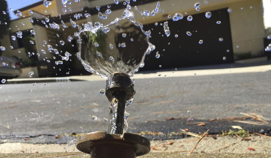 In this April 8, 2015, file photo, water runs off from a sprinkler in Mount Olympus, a neighborhood in the Hollywood Hills area of Los Angeles. Members of the state Water Resources Control Board are scheduled to decide Tuesday, Feb. 20, 2018, whether to bring back what had been temporary water bans from California&#39;s 2013-2017 drought, and make them permanent. U.S. drought monitors last week declared that a fifth of the state, all of it in Southern California, is now back in severe drought, just months after the state emerged from that category of drought. (AP Photo/Damian Dovarganes, File)