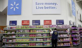 FILE- In this Nov. 9, 2017, file photo, Walmart employee Kenneth White scans items while conducting an exercise during a Walmart Academy class session at the store in North Bergen, N.J. Walmart reports financial results Tuesday, Feb. 20, 2018. (AP Photo/Julio Cortez, File)