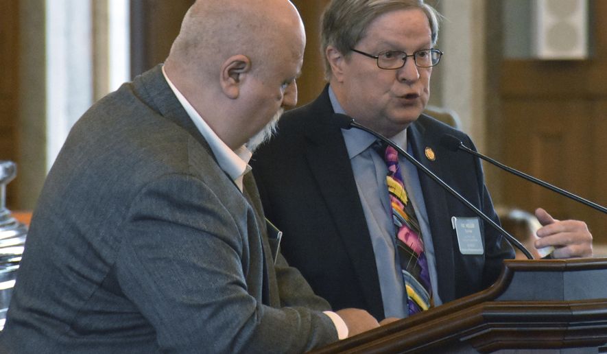 Kansas state Rep. Vic Miller, right, D-Topeka, answers questions from Rep. Michael Houser, R-Columbus, during a debate on a bill setting the minimum age to run for governor at 18, Tuesday, Feb 20, 2018, at the Statehouse in Topeka, Kan. The measure was inspired by a raft of teenage candidates running this year. (AP Photo/Mitchell Willetts)