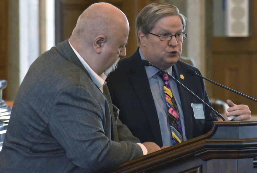 Kansas state Rep. Vic Miller, right, D-Topeka, answers questions from Rep. Michael Houser, R-Columbus, during a debate on a bill setting the minimum age to run for governor at 18, Tuesday, Feb 20, 2018, at the Statehouse in Topeka, Kan. The measure was inspired by a raft of teenage candidates running this year. (AP Photo/Mitchell Willetts)