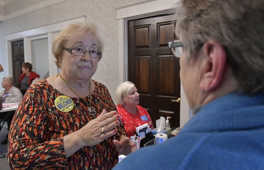 Linda Belcher, left, the Democratic candidate for the Kentucky House of Representatives representing the 49th District speaks with a supporter during a rally, Tuesday, Feb. 13, 2018, in Shepherdsville, Ky. Belcher, a former representative for the district is running in a special election being held Tuesday, to fill the seat that is now vacant following the suicide of the former representative, Dan Johnson, following his suicide in 2017. (AP Photo/Timothy D. Easley)