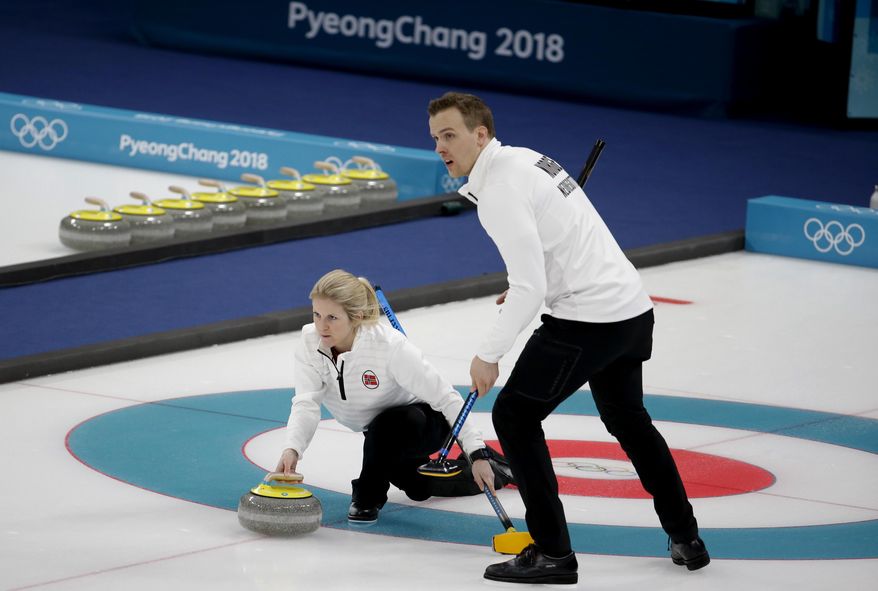 FILE - In this Feb. 13, 2018 file photo, Norway's Kristin Skaslien, left, throws the stone as teammate Magnus Nedregotten looks on during the mixed doubles bronze medal curling match against Russian athletes Anastasia Bryzgalova and Alexander Krushelnitsky at the 2018 Winter Olympics in Gangneung, South Korea. Nedregotten and his partner, who lost out on the Olympic bronze medal to Krushelnitsky, charged with doping, said Tuesday, Feb. 20 he feels robbed of his moment of glory. (AP Photo/Natacha Pisarenko, File)
