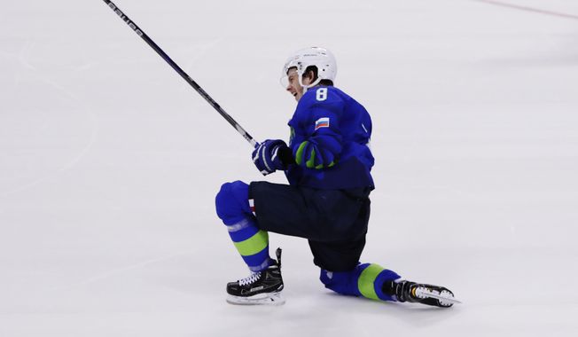 Ziga Jeglic, of Slovenia, celebrates after scoring a goal during the penalty shootout period of the preliminary round of the men&#x27;s hockey game against Slovakia at the 2018 Winter Olympics in Gangneung, South Korea, Saturday, Feb. 17, 2018. (AP Photo/Frank Franklin II)