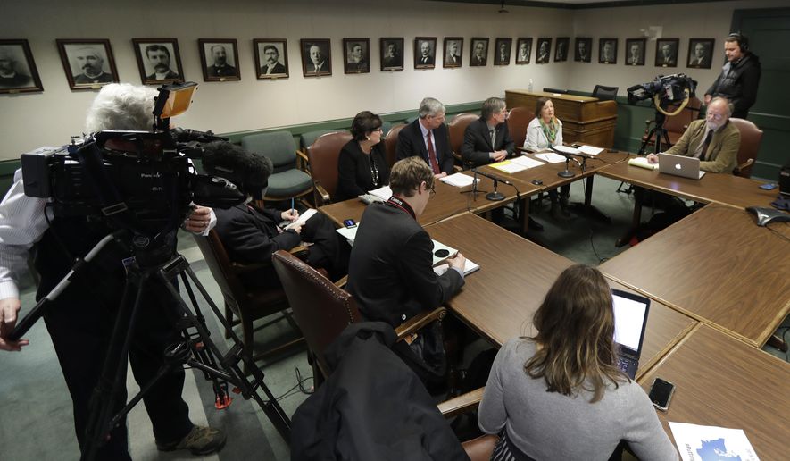 House Democrat leaders, center, talk to reporters about their proposed supplemental budget, Tuesday, Feb. 20, 2018, during a news conference at the Capitol in Olympia, Wash. The budget proposal sticks to an education funding timeline that the state Supreme Court has previously rejected and also includes a capital gains tax for long-term property tax relief. (AP Photo/Ted S. Warren)