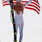 Lindsey Vonn raises the American flag after earning the bronze medal in the women&#39;s downhill skiing final on Wednesday at the Winter Olympics.