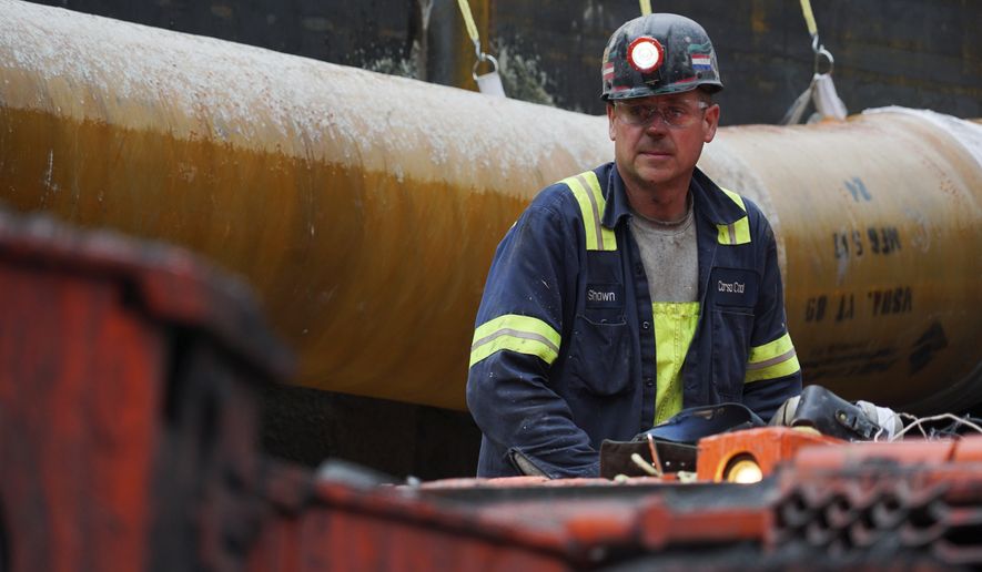 A miner runs a coal continuous miner at a coal mine in Friedens, Pa., Wednesday, June 7, 2017. Corsa Coal Corp. says the mine will create 70 to 100 new jobs and produce some 400,000 tons of metallurgical coal a year. President Donald Trump referred to the mine&#x27;s opening during a speech announcing his intent to withdraw from the Paris climate accords. (AP Photo/Dake Kang)