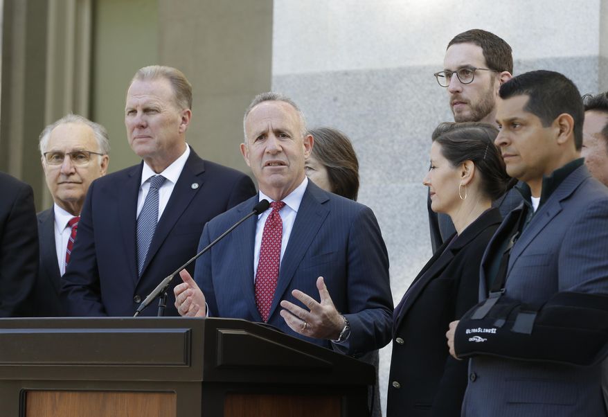 Sacramento Mayor Darrell Steinberg, center, discusses California's growing homeless crisis during a news conference, Wednesday, Feb. 21, 2018, in Sacramento, Calif. Steinberg was accompanied by other California mayors and state lawmakers, including Fresno Mayor Lee Brand, left, San Diego Mayor Kevin Faulconer, second from left, Oakland Mayor Libby Schaaf, third from right, and Assemblymen Miguel Santiago, D-Los Angeles, second from right, and David Chiu, D-San Francisco, right. They are backing a bill calling for the state to provide $1.5 billion, to be matched by the cities, to create a $3 billion one-time fund to help provide housing, temporary shelters, supportive services and outreach. Standing behind Schaaf is state Sen. Scott Wiener, D-San Francisco. (AP Photo/Rich Pedroncelli)