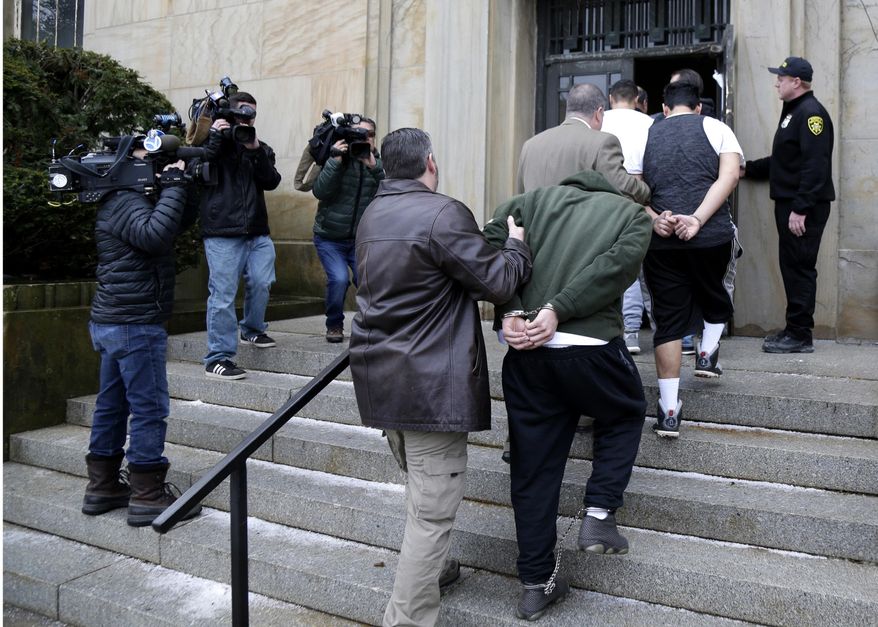 In this Jan. 11, 2018, file photo, suspected members of the MS-13 gang are escorted to their arraignment in Mineola, N.Y. A sweep of alleged MS-13 gang members on Long Island has racked up impressive arrest totals but also left unanswered questions. Since May, federal authorities say they've arrested more than 220 members of the notorious street gang. But authorities have largely declined multiple requests by for even the most basic information about the arrests. (AP Photo/Seth Wenig, File)