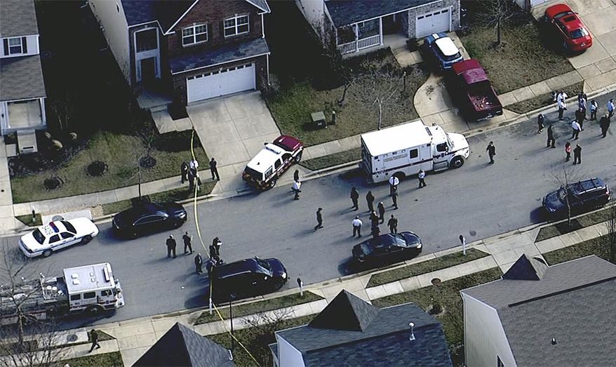 In this image made from video and released by WJLA-TV, authorities work where a police officer was shot, Wednesday, Feb. 21, 2018, in Prince George's County, Md. (WJLA-TV via AP)