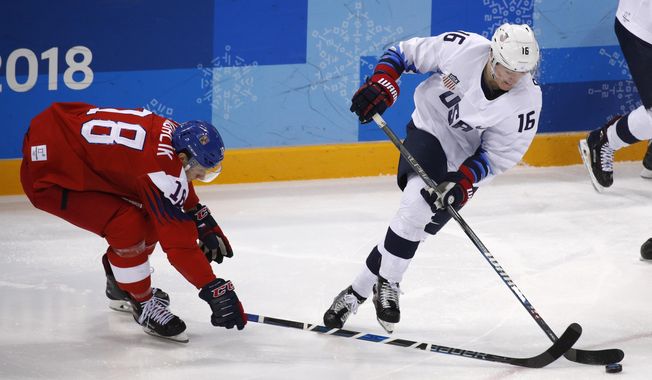 Ryan Donato (16), of the United States, skates with the puck past Dominik Kubalik (18), of the Czech Republic, during the second period of the quarterfinal round of the men&#x27;s hockey game at the 2018 Winter Olympics in Gangneung, South Korea, Wednesday, Feb. 21, 2018. (AP Photo/Jae C. Hong)