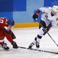 Ryan Donato (16), of the United States, skates with the puck past Dominik Kubalik (18), of the Czech Republic, during the second period of the quarterfinal round of the men&#39;s hockey game at the 2018 Winter Olympics in Gangneung, South Korea, Wednesday, Feb. 21, 2018. (AP Photo/Jae C. Hong)