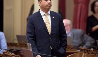 FILE - In this Jan. 3, 2018 file photo, state Sen. Tony Mendoza, D-Artesia, stands at his desk after announcing that he will take a month-long leave of absence while an investigation into sexual misconduct allegations against him are completed, during the opening day of the Senate in Sacramento, Calif. Mendoza announced Thursday, Feb. 22, 2018 that he is resigning over sexual misconduct allegations just ahead of a possible vote by his colleagues to expel him. In his resignation letter, Mendoza called the Senate&#x27;s process &amp;quot;farcical&amp;quot; and unfair and is still considering running for re-election in the fall. (AP Photo/Steve Yeater, File)