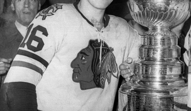 FILE - In this April 16, 1961, file photo, Chicago Blackhawks hockey player Bobby Hull smiles in the dressing room beside the Stanley Cup after Chicago defeated the Detroit Red Wings, 5-1, to win the NHL Championship, in Detroit. Way back in 1961, Joe Serpico got a pair of game-worn jerseys from Chicago Blackhawks stars Bobby Hull and Glenn Hall for his 10th birthday. It was a gift from his beloved uncle Jerry &amp;quot;The Barber&amp;quot; Del Giudice, who served as the team barber for decades. Now Serpico is letting the Hull jersey go as part of an auction while remembering everything he loves about his family and his favorite hockey team.  (AP Photo/File)