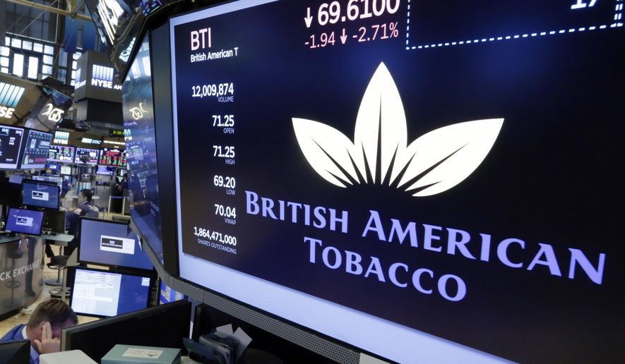 FILE - This is a Monday, July 24, 2017 file photo of the logo for British American Tobacco appears above a trading post on the floor of the New York Stock Exchange. Dutch prosecutors said Thursday Feb. 22, 2018, they will not open a criminal investigation into four major tobacco companies on charges including attempted murder or manslaughter, saying such a case would be unlikely to lead to a conviction. Amsterdam lawyer Benedicte Ficq had called for the prosecution of Philip Morris, British American Tobacco, Japan Tobacco International and Imperial Tobacco Benelux. (AP Photo/Richard Drew/File)