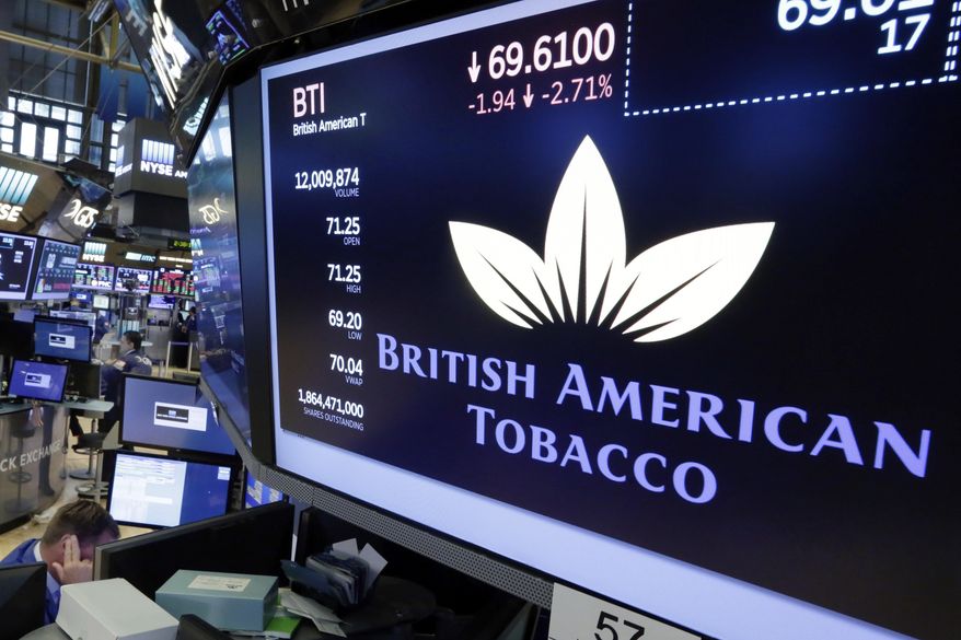 FILE - This is a Monday, July 24, 2017 file photo of the logo for British American Tobacco appears above a trading post on the floor of the New York Stock Exchange. Dutch prosecutors said Thursday Feb. 22, 2018, they will not open a criminal investigation into four major tobacco companies on charges including attempted murder or manslaughter, saying such a case would be unlikely to lead to a conviction. Amsterdam lawyer Benedicte Ficq had called for the prosecution of Philip Morris, British American Tobacco, Japan Tobacco International and Imperial Tobacco Benelux. (AP Photo/Richard Drew/File)