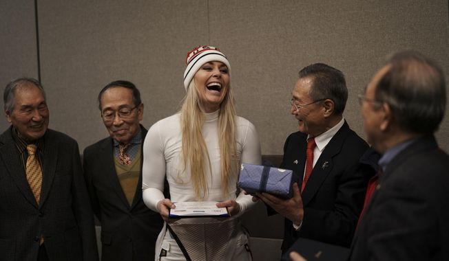 United States&#x27; Lindsey Vonn, center, smiles as she receives gifts and a letter of appreciation for her grandfather&#x27;s service during the Korean War from members of the Yongsan Club in Jeongseon, South Korea, Thursday, Feb. 22, 2018. (AP Photo/Felipe Dana)