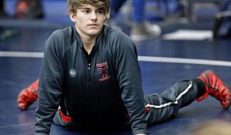 In this Saturday, Feb. 17, 2018 photo, Trinity High School wrestler Mack Beggs warms up before her match at the 6A Region II wrestling meet held at Allen High School in Allen, Texas . Beggs, a senior from Euless Trinity High School near Dallas is transgender and in the process of transitioning from female to male. (Stewart F. House/The Dallas Morning News via AP)