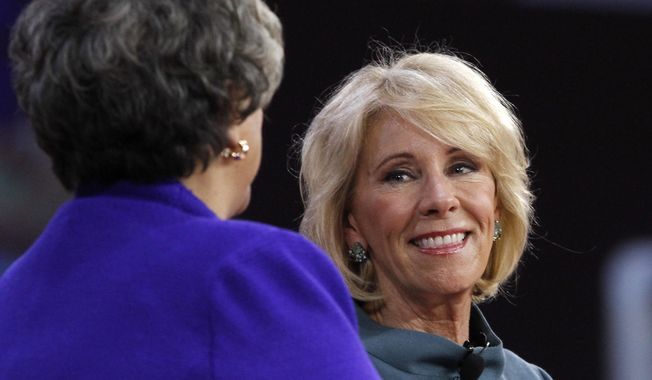 Education Secretary Betsy DeVos, right, smiles after speaking at the Conservative Political Action Conference (CPAC), at National Harbor, Md., Thursday, Feb. 22, 2018. (AP Photo/Jacquelyn Martin)