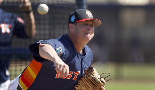 FILE - In this Feb. 19, 2018, file photo, Houston Astros pitcher Brad Peacock throws live batting practice during spring training baseball practice in West Palm Beach, Fla. Last spring Brad Peacock entered Astros camp worried that he wouldn&#x27;t make the team. After the best season of his career, the right-hander&#x27;s spot with the Astros is secure this season, but he&#x27;s maintained the same mindset he had when his career was on the line. &quot;I still want to keep that edge on me,&quot; he said.(AP Photo/Jeff Roberson) **FILE**