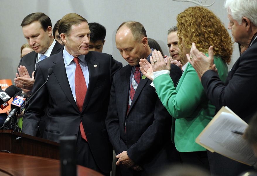 U.S. Sen. Richard Blumenthal puts his arm around Mark Barden, founder and managing director of Sandy Hook Promise, who lost a son to gun violence during a press conference, Friday, Feb. 23, 2018 in Hartford, Conn. Connecticut's Congressional delegation, including U.S. Sen. Chris Murphy, left, Rep. Elizabeth Esty and John Larson, right. (Carol Kaliff/Hearst Connecticut Media via AP) **FILE**