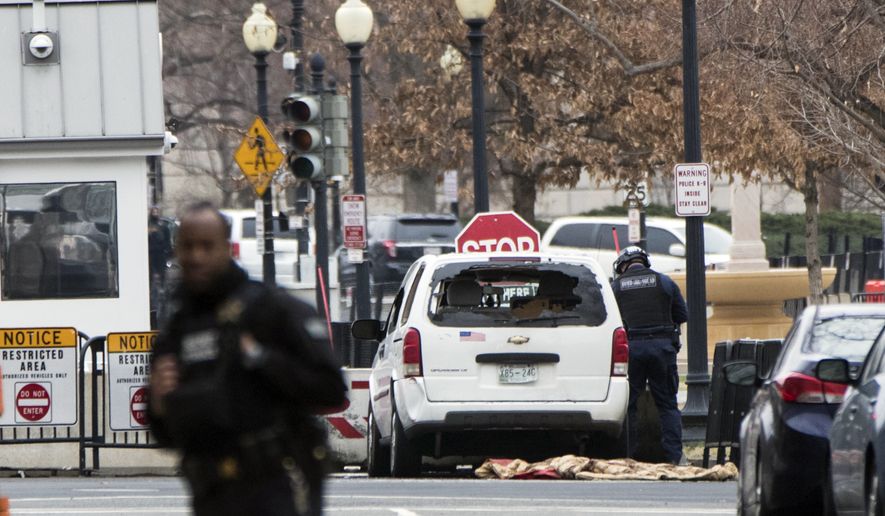 A Secret Service officer checks a white passenger vehicle that struck a security barrier a the southwest entrance to the White House grounds off of 17th Street n Washington, Friday, Feb. 23, 2018. (AP Photo/J. Scott Applewhite)