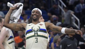 FILE - In this Feb. 10, 2018, file photo, Milwaukee Bucks guard Jason Terry (3) celebrates after a score by teammate Giannis Antetokounmpo during the second half of an NBA basketball game against the Orlando Magic, in Orlando, Fla. At age 40, Terry still averages about 11 minutes a game in his 19th NBA season. He might be a step slower from the days when he was popping 3-pointers in Atlanta and Dallas. But a player nicknamed “Jet” can still most definitely take off on the court. (AP Photo/Phelan M. Ebenhack, File)