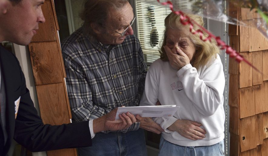 Jo-Ann Snyder reacts when she see's the check from Publishers Clearing House at her home in Wilkes-Barre Twp., Friday, Feb. 23, 2018. (Aimee Dilger/The Times Leader via AP)