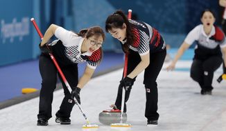 In this Feb. 21, 2018 photo, South Korea&#39;s Kim Seonyeong, left, sweeps ice with teammate during their match against Russian athletes at the 2018 Winter Olympics in Gangneung, South Korea. The team known as the &amp;quot;Garlic Girls&amp;quot; came into the Pyeongchang Games as the underdog who few believed would medal. Now they&#39;re No. 1 in the rankings. (AP Photo/Aaron Favila)