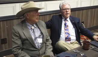 Southern Nevada rancher Cliven Bundy, left, listens to Independent American Party of Nevada Chairman Joel Hansen before Bundy was scheduled to give the keynote address to the third-party&#39;s state convention at the Nugget hotel-casino, Friday, Feb. 23, 2018, in Sparks, Nev. Bundy served 700 days in jail before a U.S. judge in Las Vegas threw out the criminal charges against him and others last month stemming from an armed standoff with federal agents at his ranch near Bunkerville in April 2014. (AP Photo/Scott Sonner)