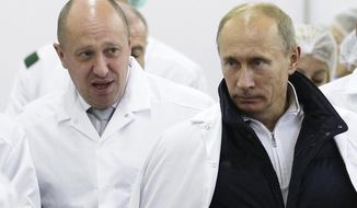 FILE - In this Monday, Sept. 20, 2010 file photo, businessman Yevgeny Prigozhin, left, shows Russian President Vladimir Putin, around his factory which produces school means, outside St. Petersburg, Russia. One of those indicted in the Russia probe is a businessman with ties to Russian President Vladimir Putin. Prigozhin is an entrepreneur from St. Petersburg who&#39;s been dubbed &amp;quot;Putin&#39;s chef&amp;quot; by Russian media. His restaurants and catering businesses have hosted the Kremlin leader&#39;s dinners with foreign dignitaries. (Alexei Druzhinin, Sputnik, Kremlin Pool Photo via AP, File)