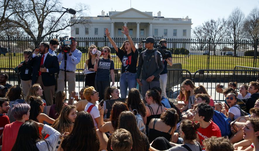 FILE - In this Wednesday, Feb. 21, 2018 file photo, demonstrators take part in a student protest for gun control legislation in front of the White House, in Washington. Dozens of college and universities are telling students who may face discipline at their high schools for participating in gun control demonstrations to relax: It won&#39;t affect their chances of getting into their schools. Nearly 50 schools including Yale, Dartmouth and UCLA have taken to social media to reassure the students. (AP Photo/Evan Vucci, File)
