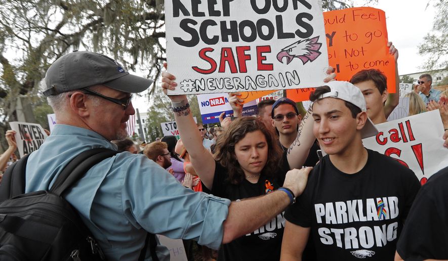 FILE - In this Wednesday, Feb. 21, 2018 file photo, student survivors from Marjory Stoneman Douglas High School are greeted as they arrive at a rally for gun control reform on the steps of the state capitol, in Tallahassee, Fla. Dozens of college and universities are telling students who may face discipline at their high schools for participating in gun control demonstrations to relax: It won&#x27;t affect their chances of getting into their schools. Nearly 50 schools including Yale, Dartmouth and UCLA have taken to social media to reassure the students. (AP Photo/Gerald Herbert, File)