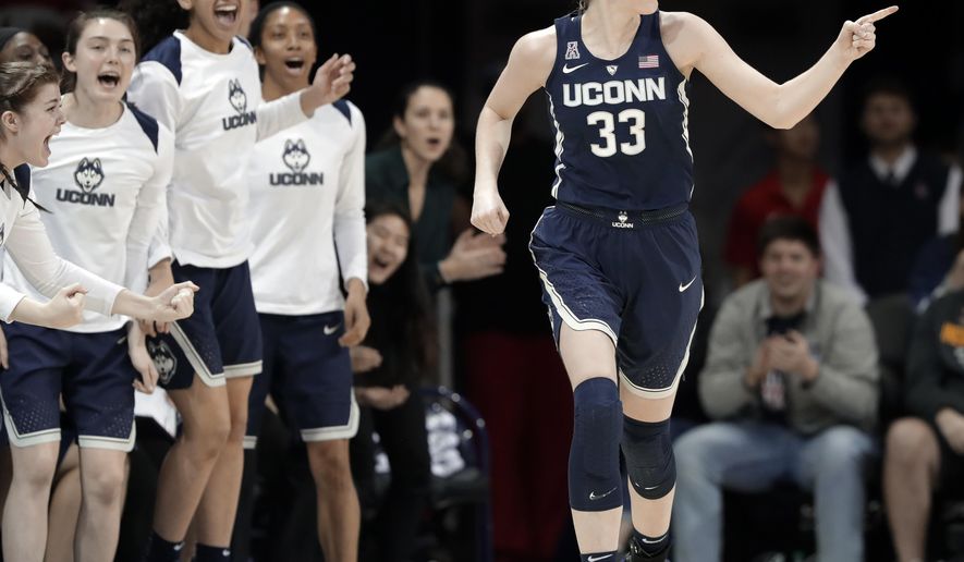 Connecticut guard/forward Katie Lou Samuelson (33) and players on the bench celebrate a 3-point basket by Samuelson against SMU during the second half of an NCAA college basketball game Saturday, Feb. 24, 2018, in Dallas. (AP Photo/Tony Gutierrez)