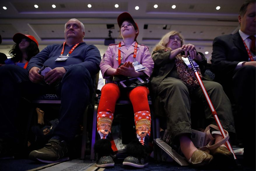 Millie March, 12, of Fairfax, Virginia, showed off her socks with the image of President Trump while awaiting his speech. (Associated Press)