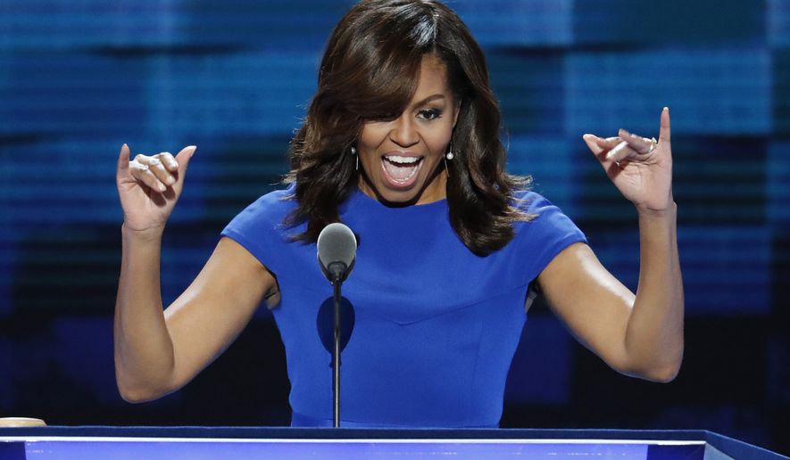 First Lady Michelle Obama waves to delegates during the first day of the Democratic National Convention in Philadelphia , Monday, July 25, 2016. (AP Photo/J. Scott Applewhite)