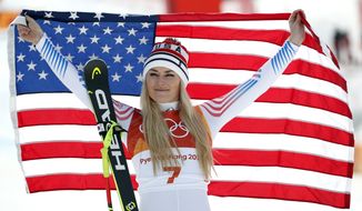 FILE - In this Feb. 21, 2018 file photo, bronze medal winner Lindsey Vonn, of the United States, celebrates during the flower ceremony for the women&#39;s downhill at the 2018 Winter Olympics in Jeongseon, South Korea. With Vonn and Ted Ligety likely on the way out, alpine skiing is heading for a major changing of the guard after winning just one gold and three medals at these games.  That was the fewest U.S. victories since 2002, the fewest podium finishes since 2006.  (AP Photo/Christophe Ena, File) **FILE**