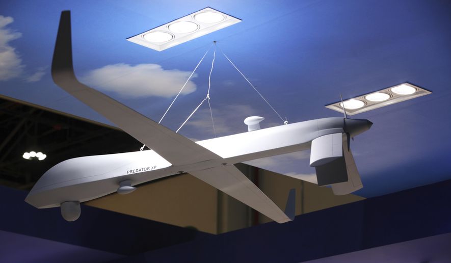 A model of a General Atomics Predator XP drone hangs on display at a drone conference in Abu Dhabi, United Arab Emirates, Sunday, Feb. 25, 2018. (AP Photo/Jon Gambrell)