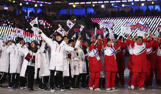 North and South Koreans wave flags during the closing ceremony of the 2018 Winter Olympics in Pyeongchang, South Korea, Sunday, Feb. 25, 2018. (AP Photo/Natacha Pisarenko)