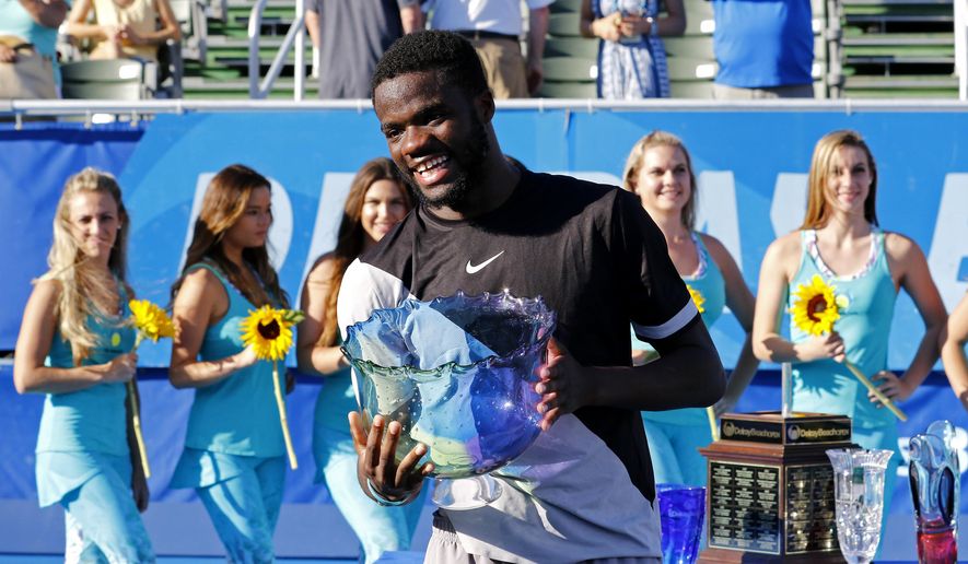 Frances Tiafoe of the U.S. holds the trophy after he defeated Peter Gojowczyk of Germany 6-1, 6-4 in his first ATP World Tour win in the 2018 Delray Beach Open, Sunday, Feb. 25, 2018, in Delray Beach, Fla. (AP Photo/Joe Skipper)