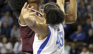 Mississippi State&#39;s Teaira McCowan, left, shoots while pressured by Kentucky&#39;s Alyssa Rice, right, during the first quarter of an NCAA college basketball game, Sunday, Feb. 25, 2018, in Lexington, Ky. (AP Photo/James Crisp)